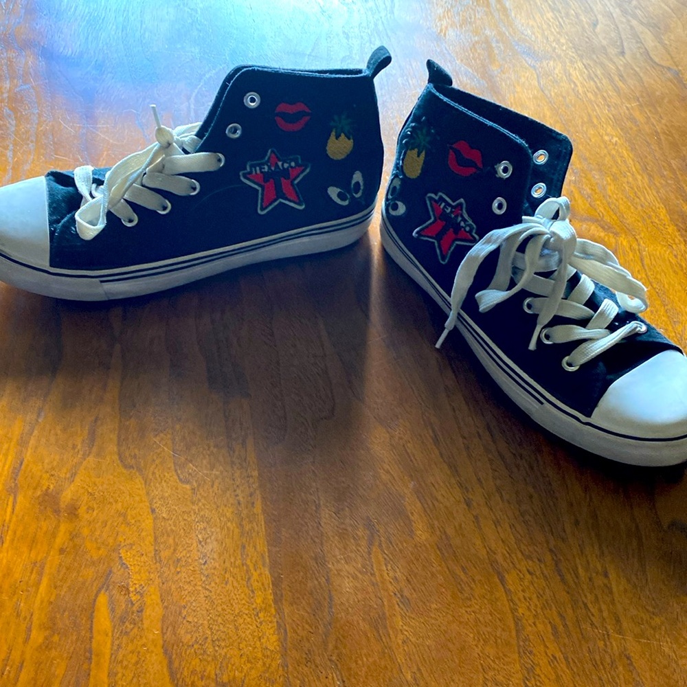 Black & white high tops tennis shoes, decals on side, pineapple lips,eyes size 7